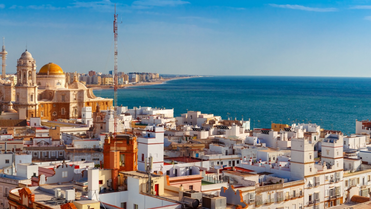 Aerial panoramic view of the old city rooftops and Cathedral de Santa Cruz in the morning from tower Tavira in Cadiz, Andalusia, Spain