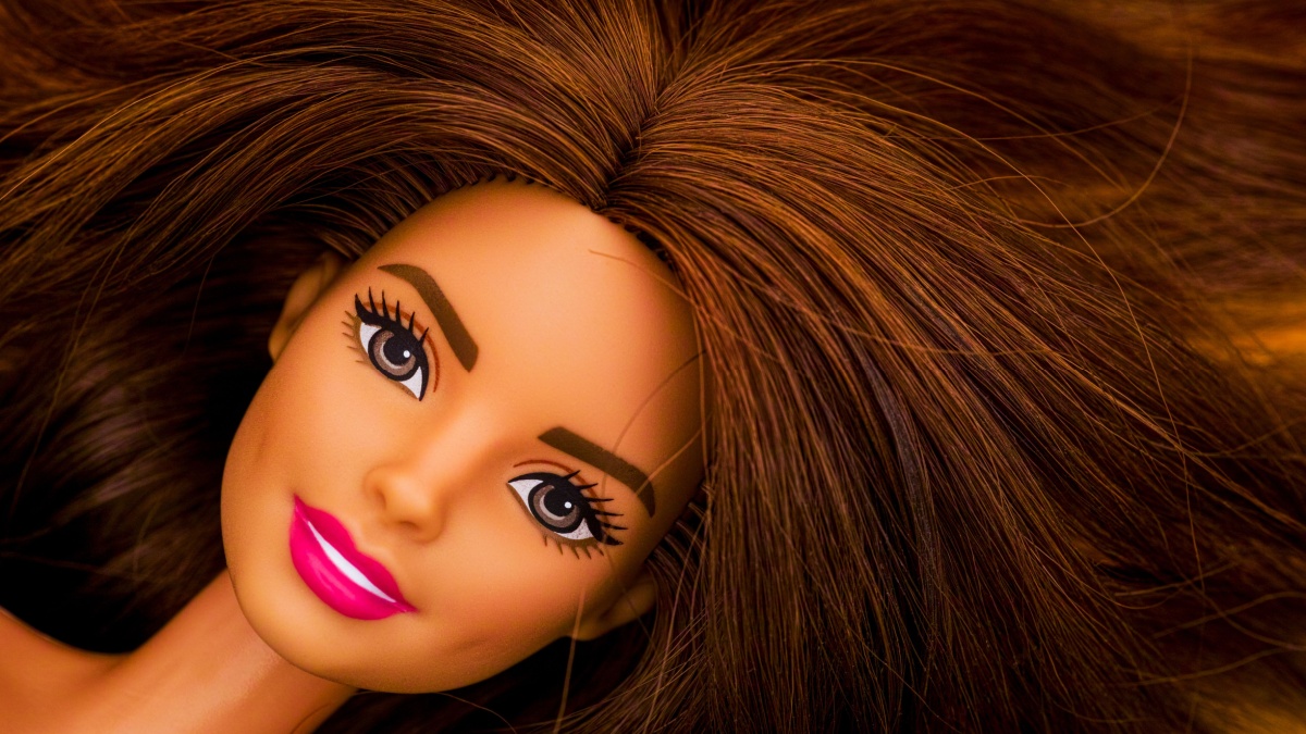 Portrait of Barbie doll with brown hair.