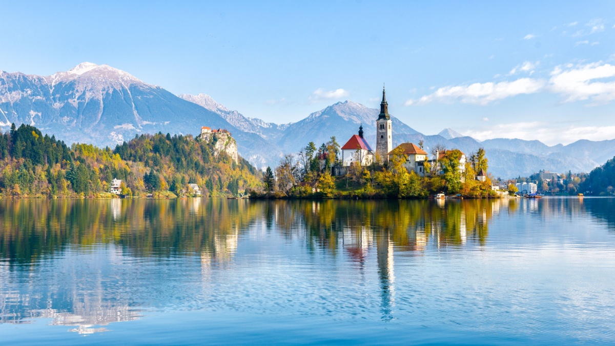 Lake Bled Slovenia. Beautiful mountain lake with small Pilgrimage Church. Most famous Slovenian lake and island Bled with Pilgrimage Church of the Assumption of Maria and Bled Castle in background.