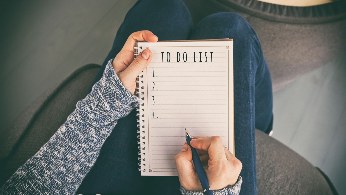 The woman is writing the to do list