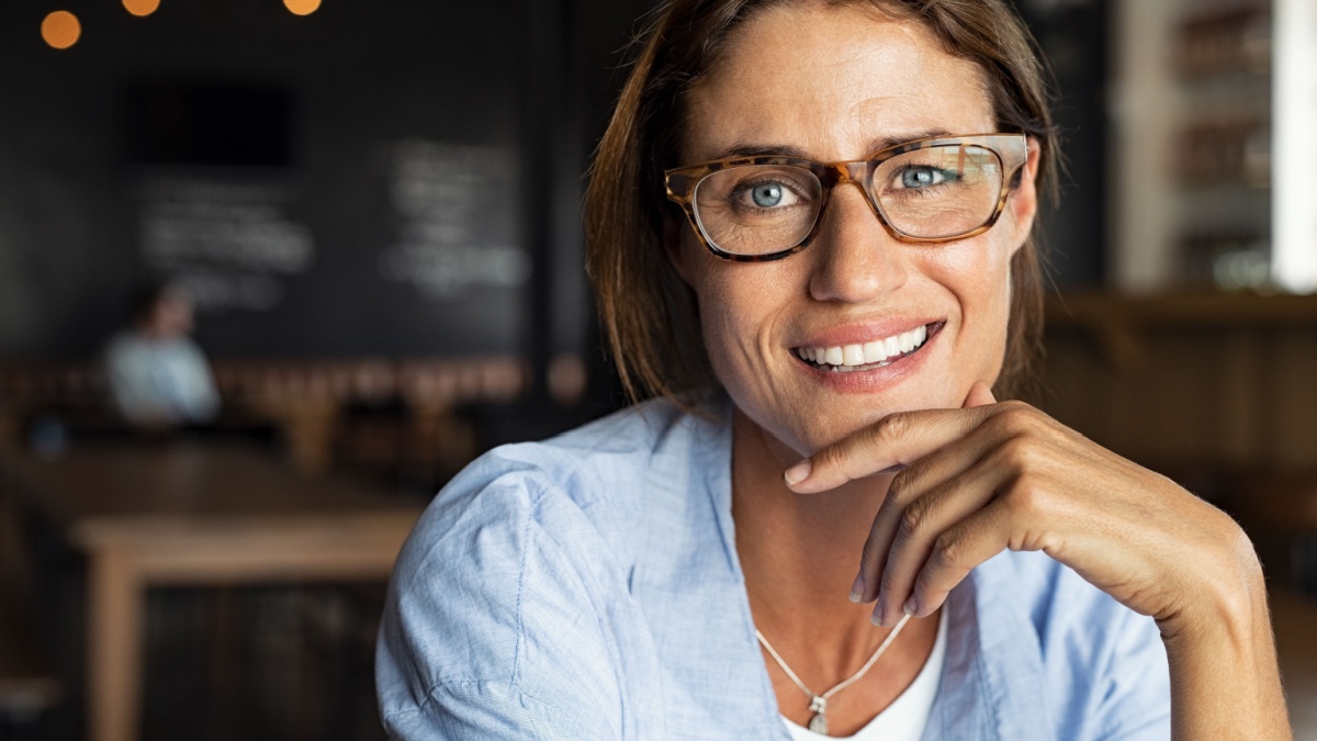 Portrait of happy mature woman wearing eyeglasses and looking at camera.