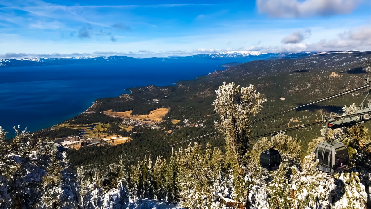 Lake tahoe view from above at heavenly Mountain Resort with gondola, clouds and dark blue lake. Lake tahoe, nevada, United States.