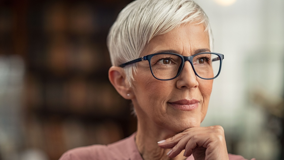 Beautiful senior business woman thinking and wearing spectacles.