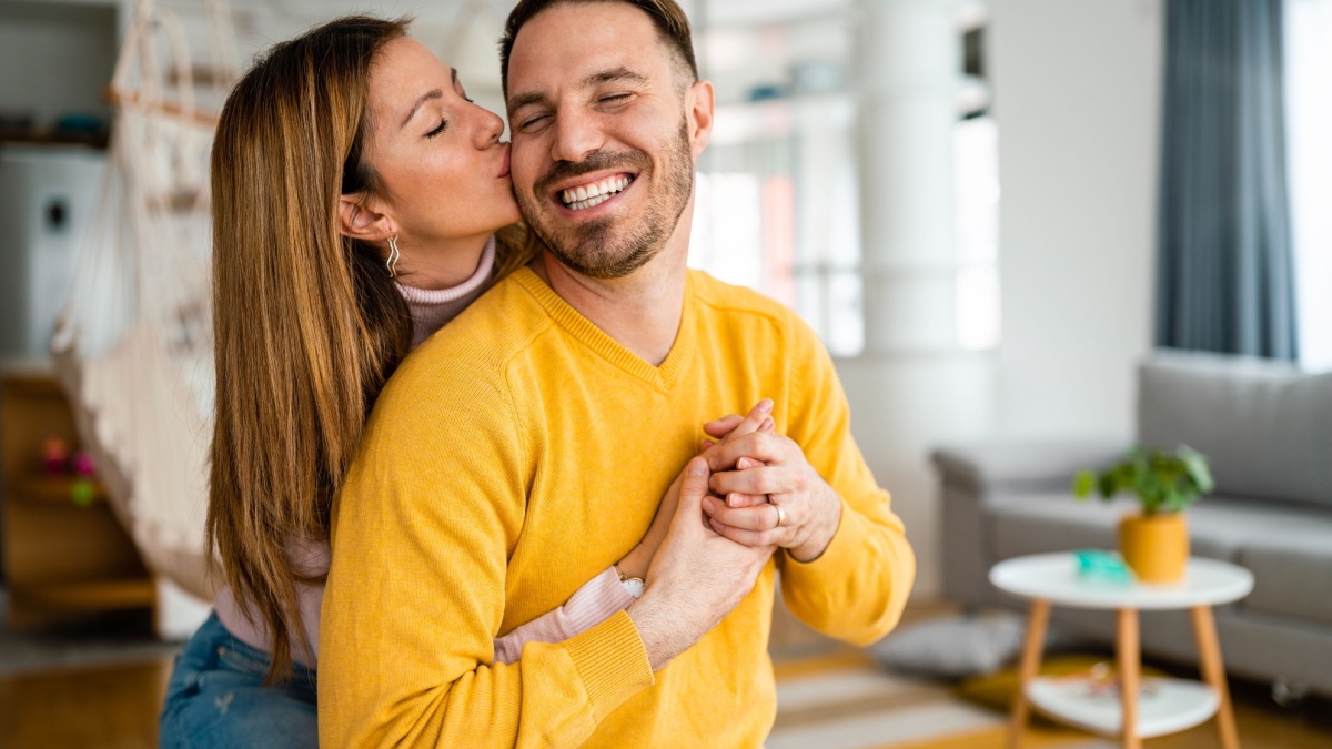 Beautiful couple in love is enjoying the company of each other at home.