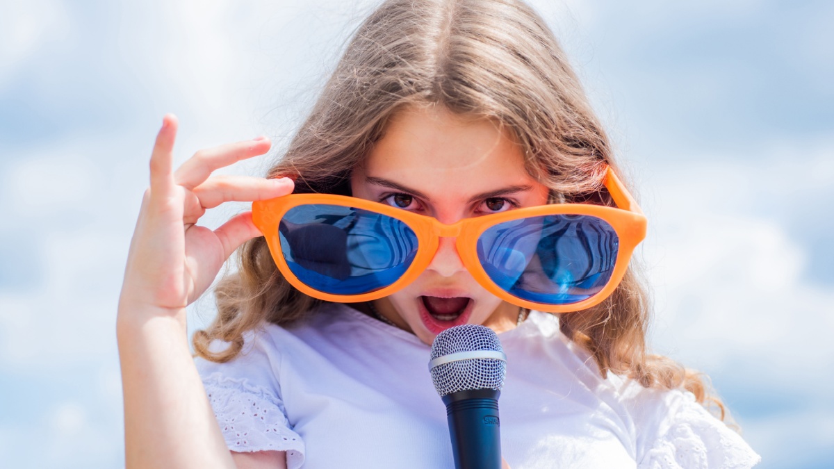Everyone deserves good music. singer in glasses with microphone. happy childhood. happy girl enjoy the moment.