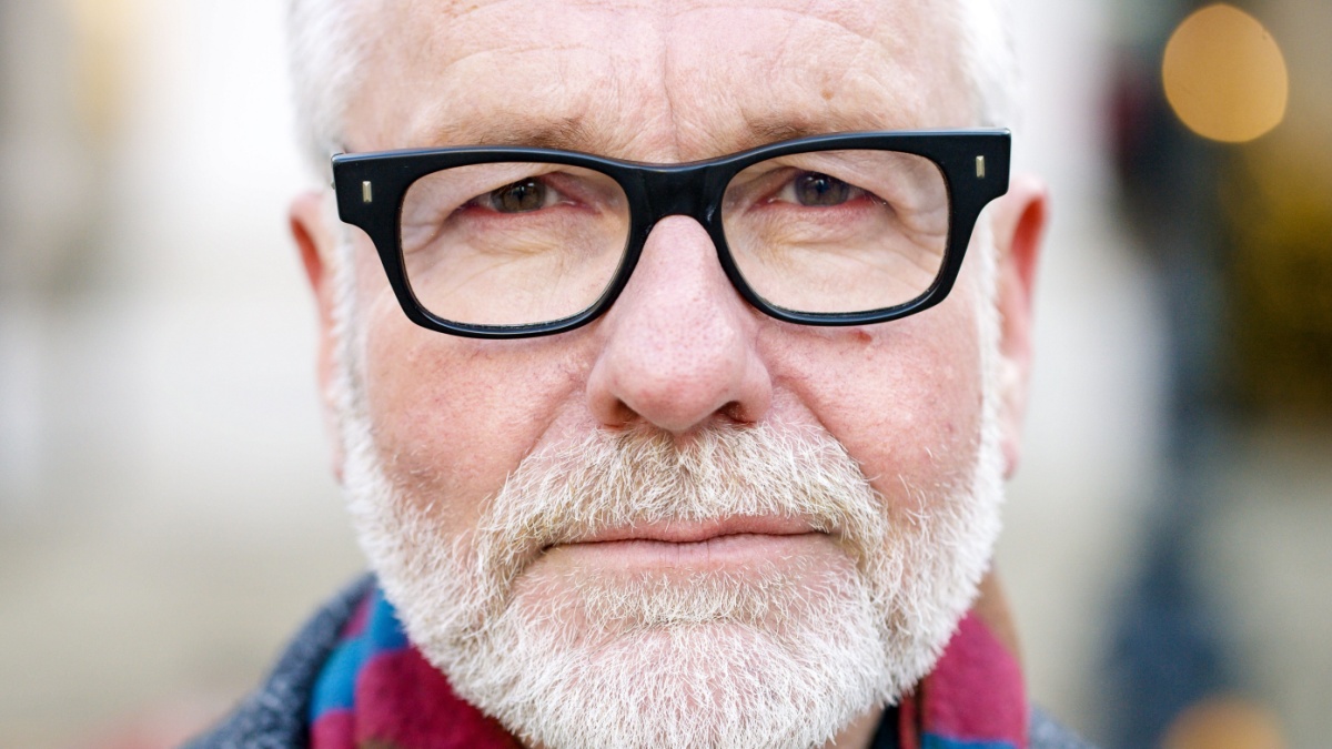 Close portrait of senior male executive looking straight to camera.