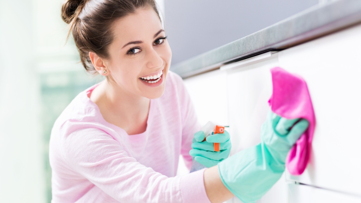 Woman cleaning kitchen.