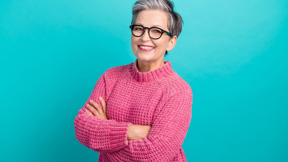Photo of positive successful person dressed knitwear sweater in glasses holding arms crossed smile isolated on teal color background.